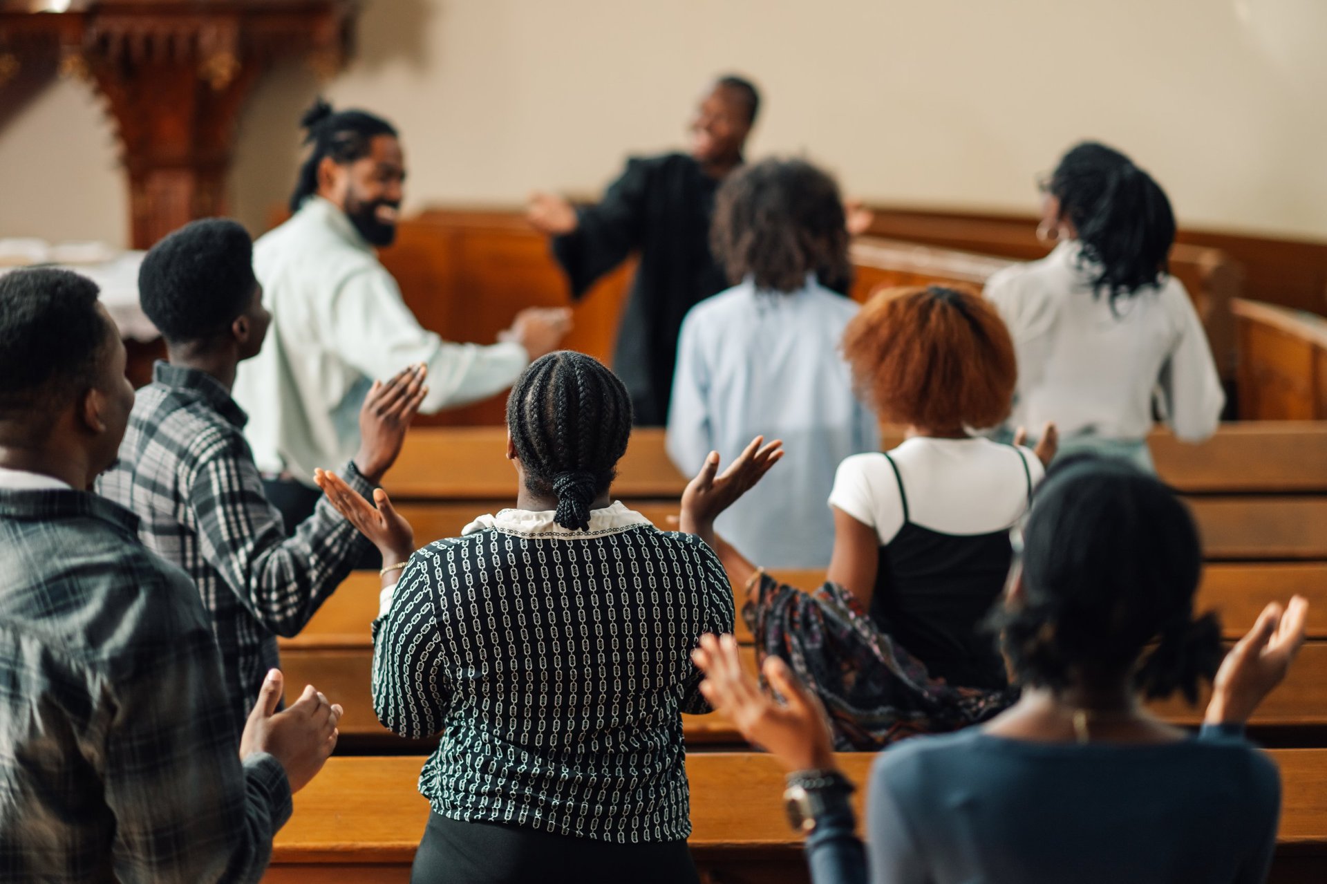 Diverse group of churchgoers singing and praying together in church