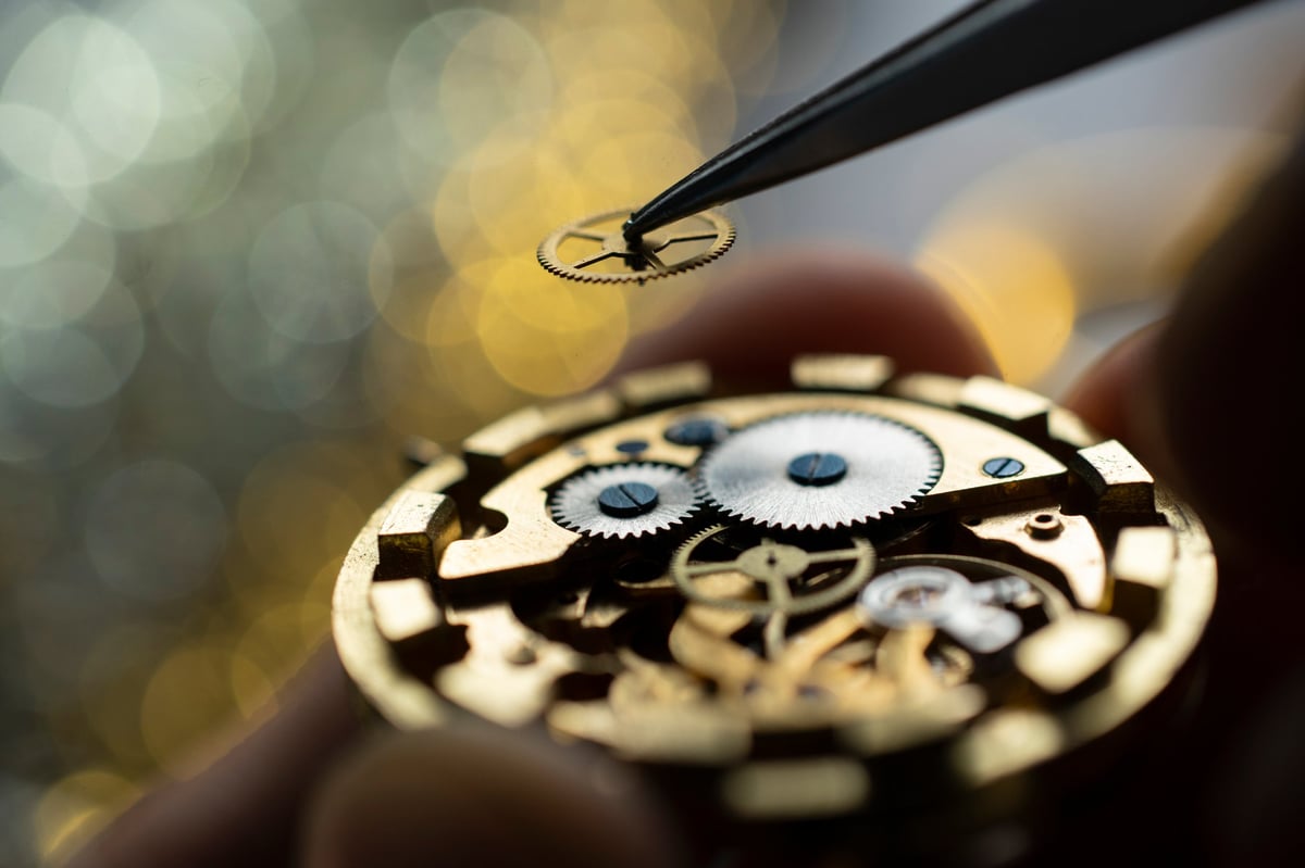Close-up of pocket watch being repaired