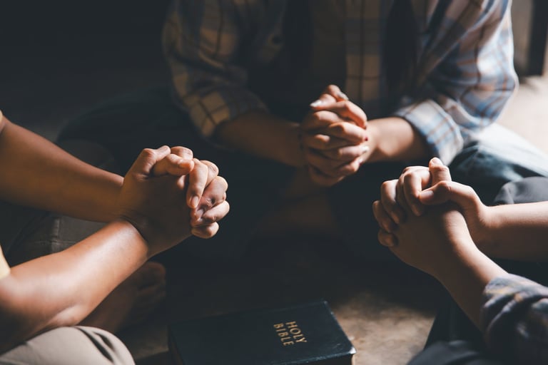 Community hands praying together in faith