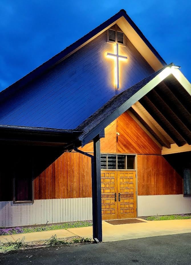 The Way of Grace church building with illuminated cross at dusk